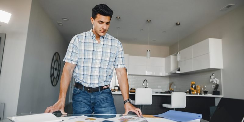 Handsome businessman in a office. Businessman in a blue shirt. Male with laptop. Young boy working